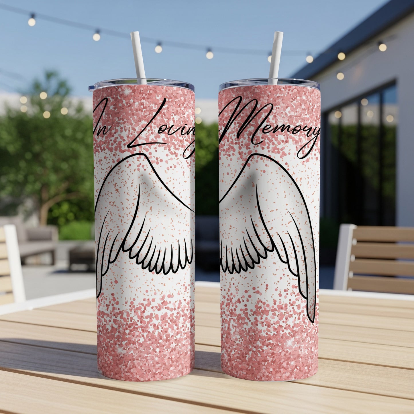Two tumblers with wings and "In Loving Memory" text on a table.