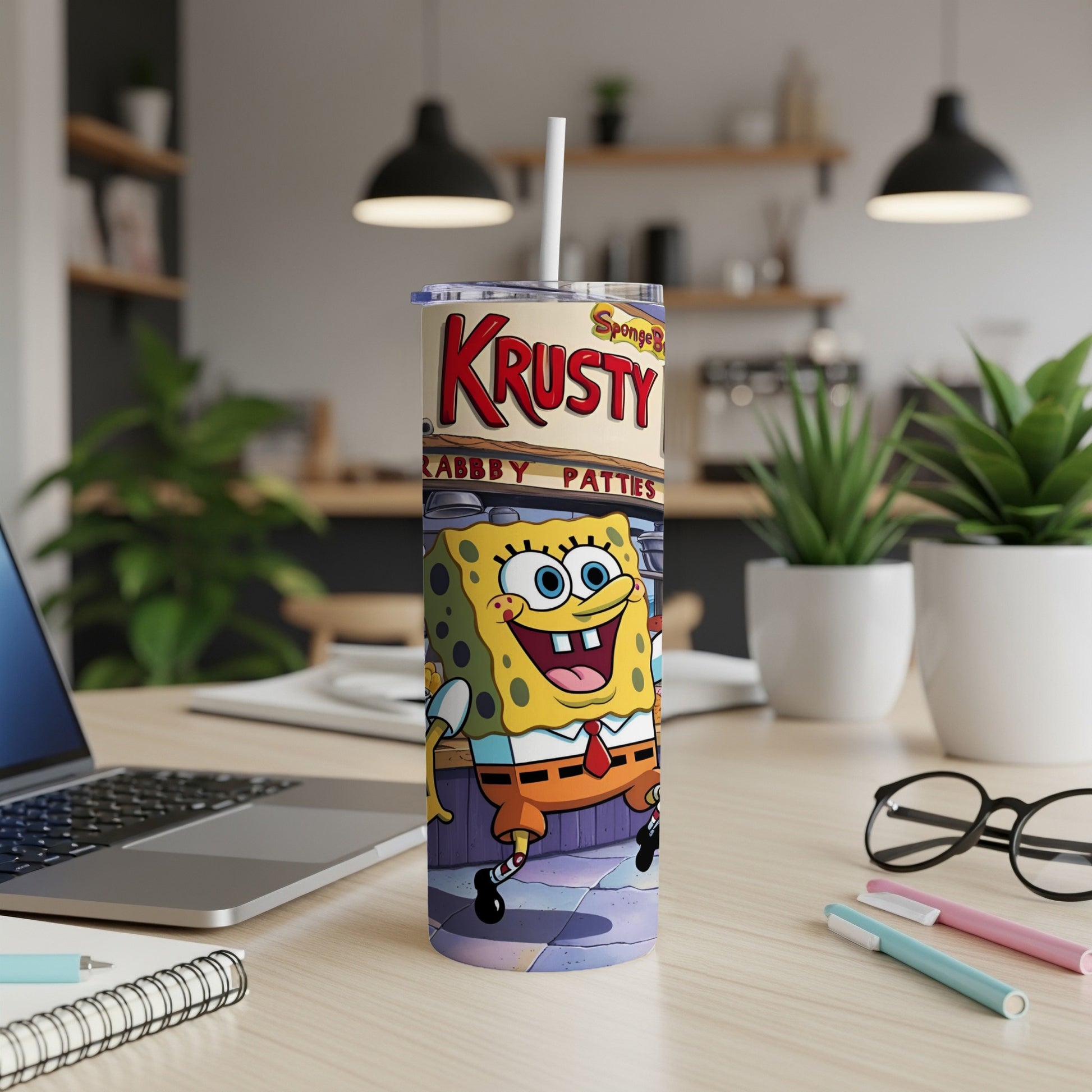 SpongeBob SquarePants on Krabby Patty tumbler with white straw.