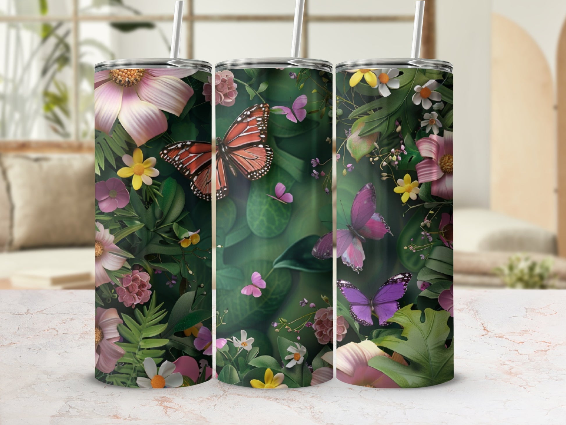 Three tumblers with colorful butterflies and floral patterns.