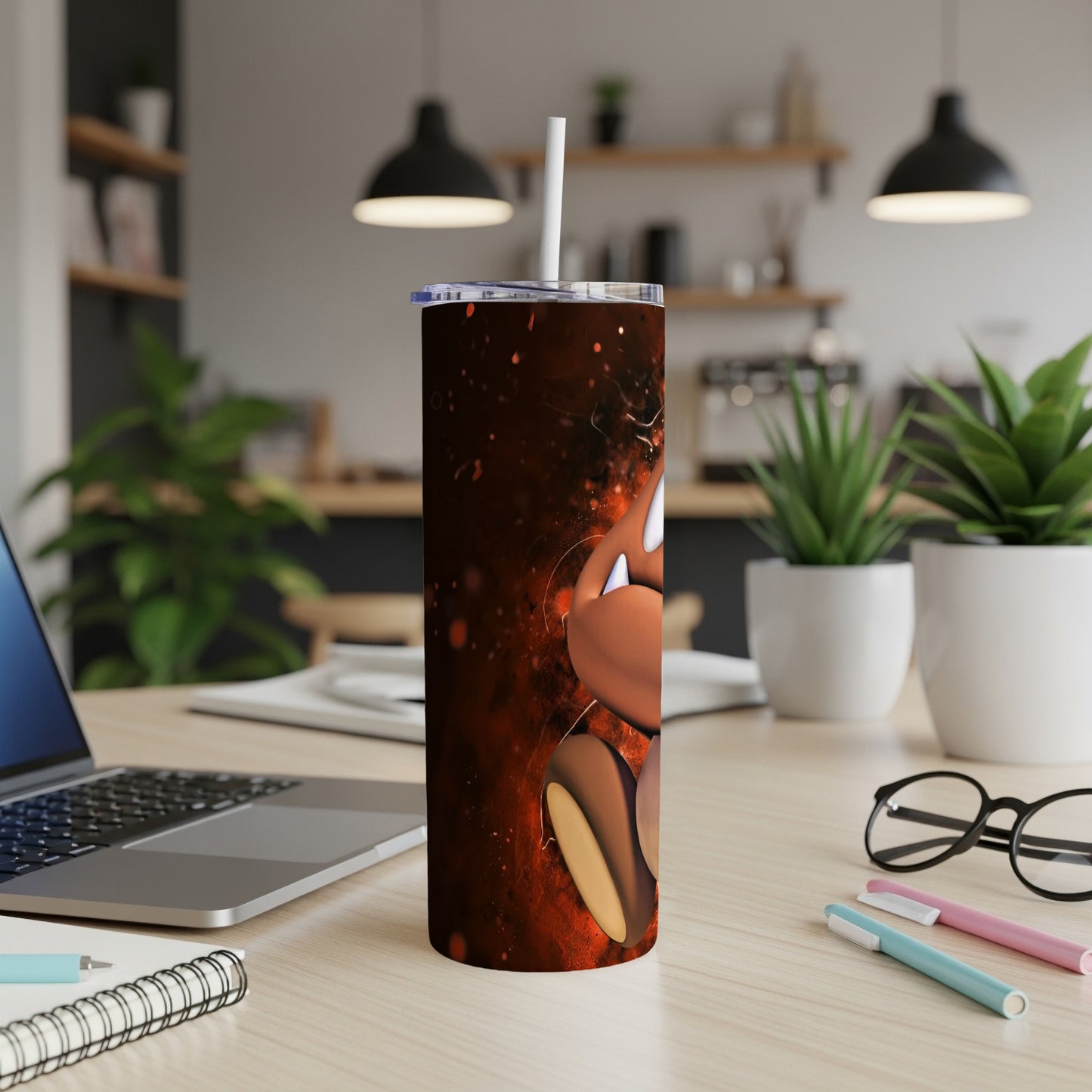 Brown cartoon character tumbler with a straw on a desk.
