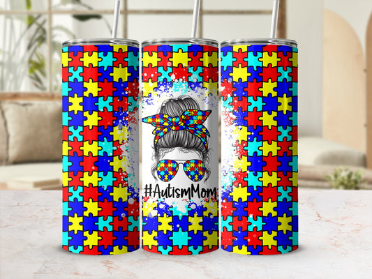 Tumbler with autism puzzle piece pattern, sunglasses, and #AutismMom text.
