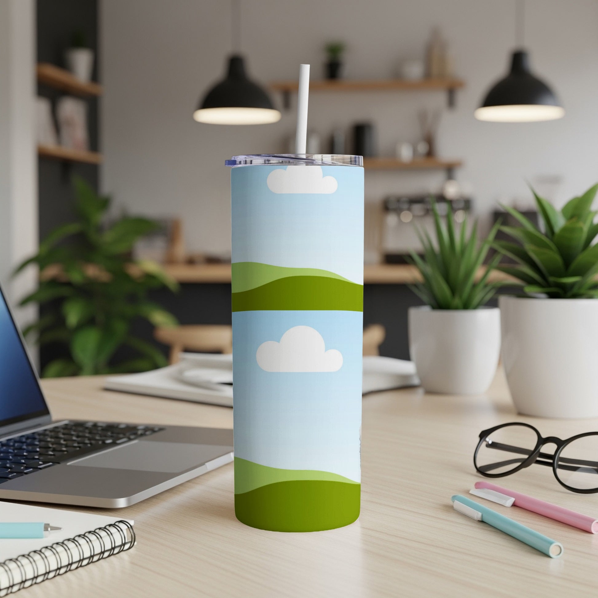 Tall tumbler with a sky and rolling hills design, includes straw.