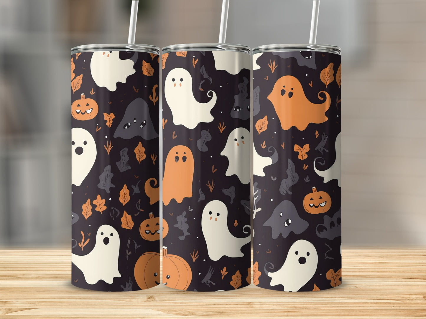 Three tumblers with a Halloween pattern of ghosts, pumpkins, and leaves.