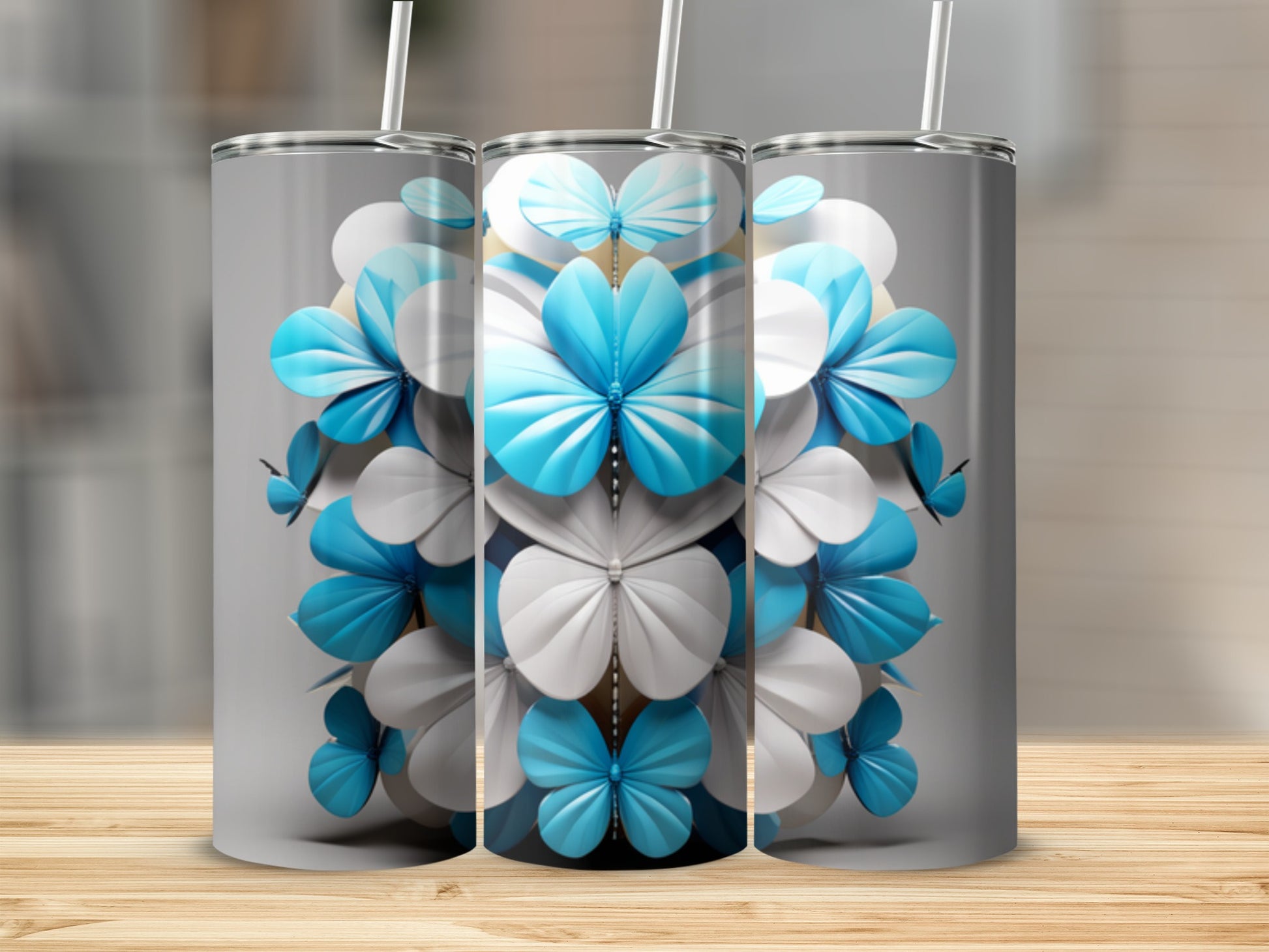 Three tumblers with a repeating pattern of white and blue floral motifs.