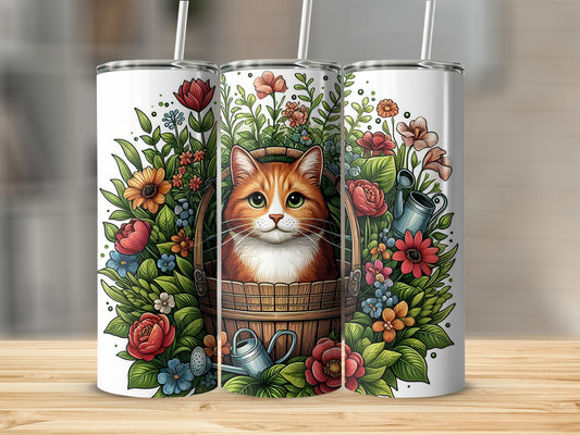 Ginger cat in a flower-filled bucket with gardening tools on a tumbler.