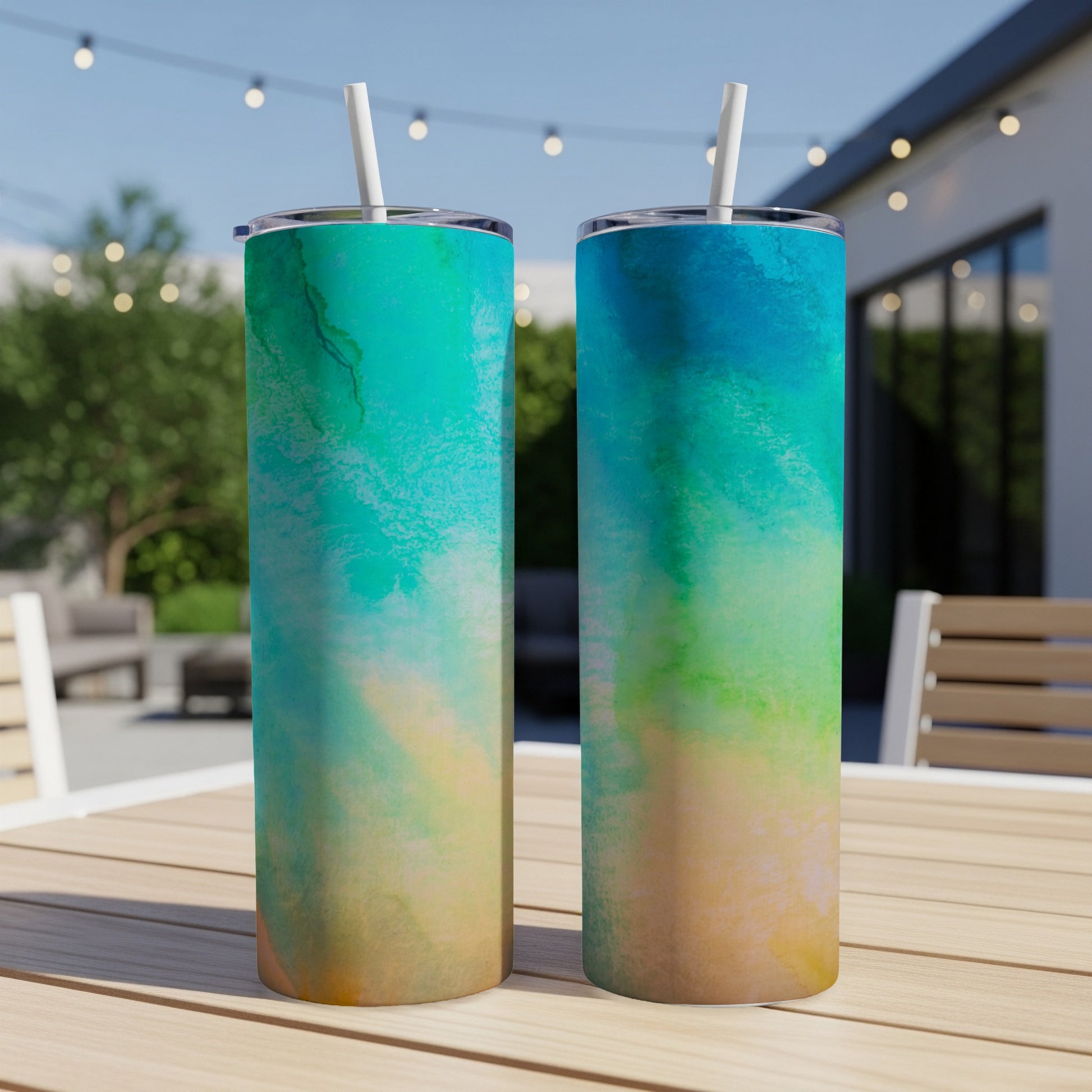 Two tumblers with abstract watercolor design in blue, green, and yellow hues.