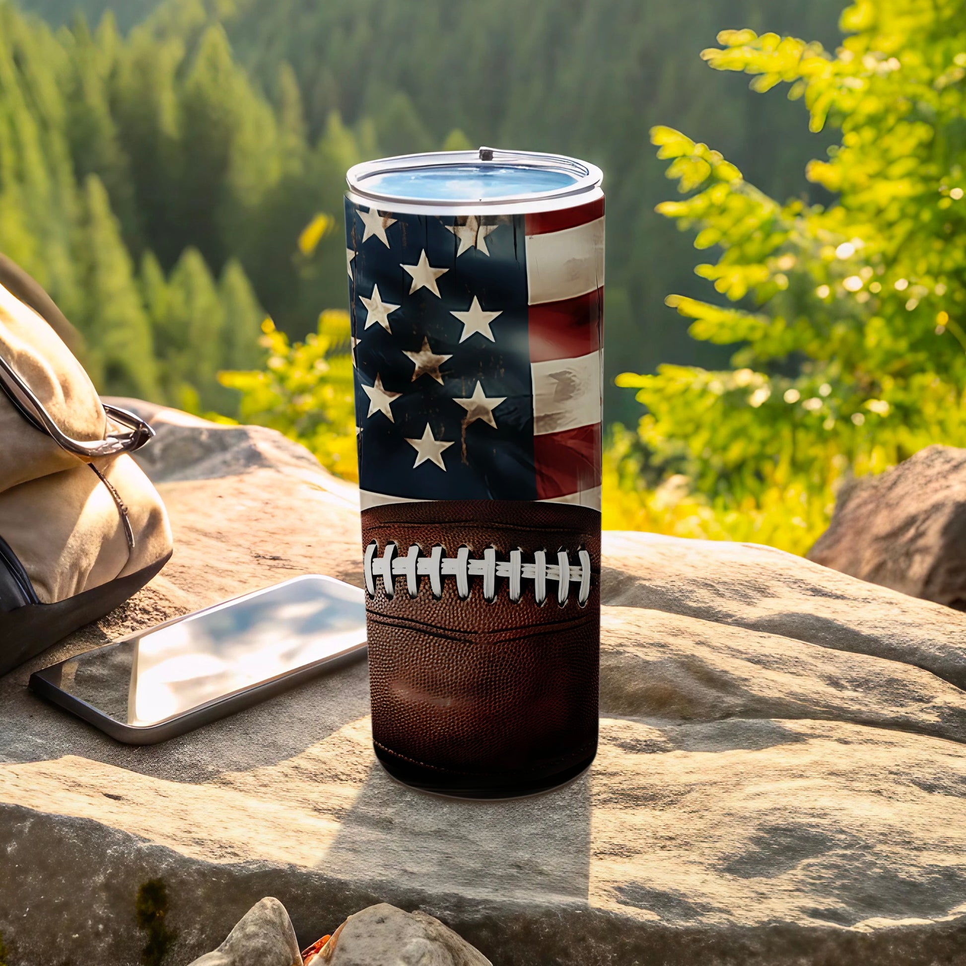 American flag and football design on a tumbler with a cell phone and backpack.
