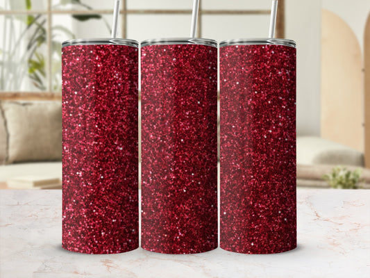 Three tall glittery red tumblers with straws on a marble surface.