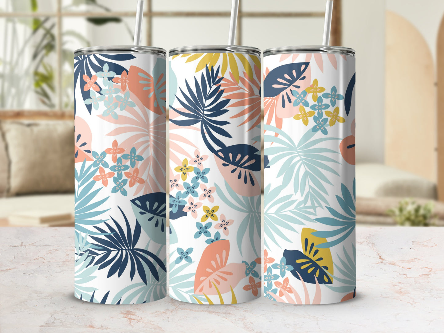 Three tumblers with a tropical floral and leaf pattern in pastel colors.