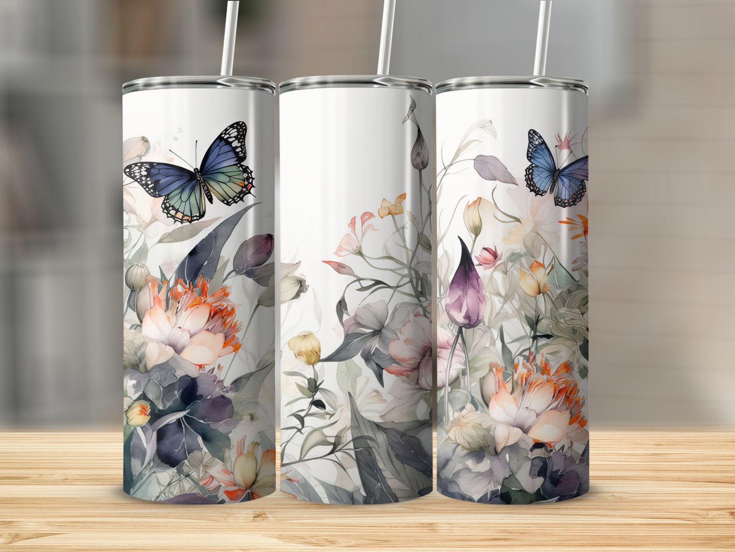 Three tumblers featuring floral designs with butterflies.