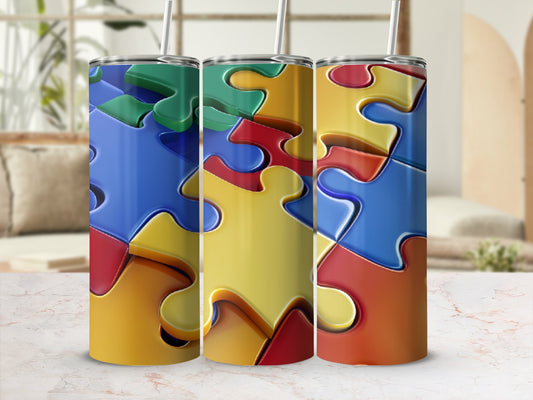 Three tumblers with colorful interlocking puzzle pieces design.