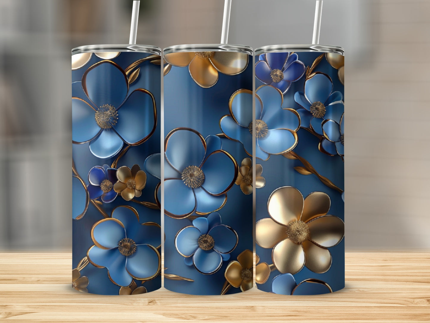 Three navy blue tumblers with metallic blue and gold floral designs.