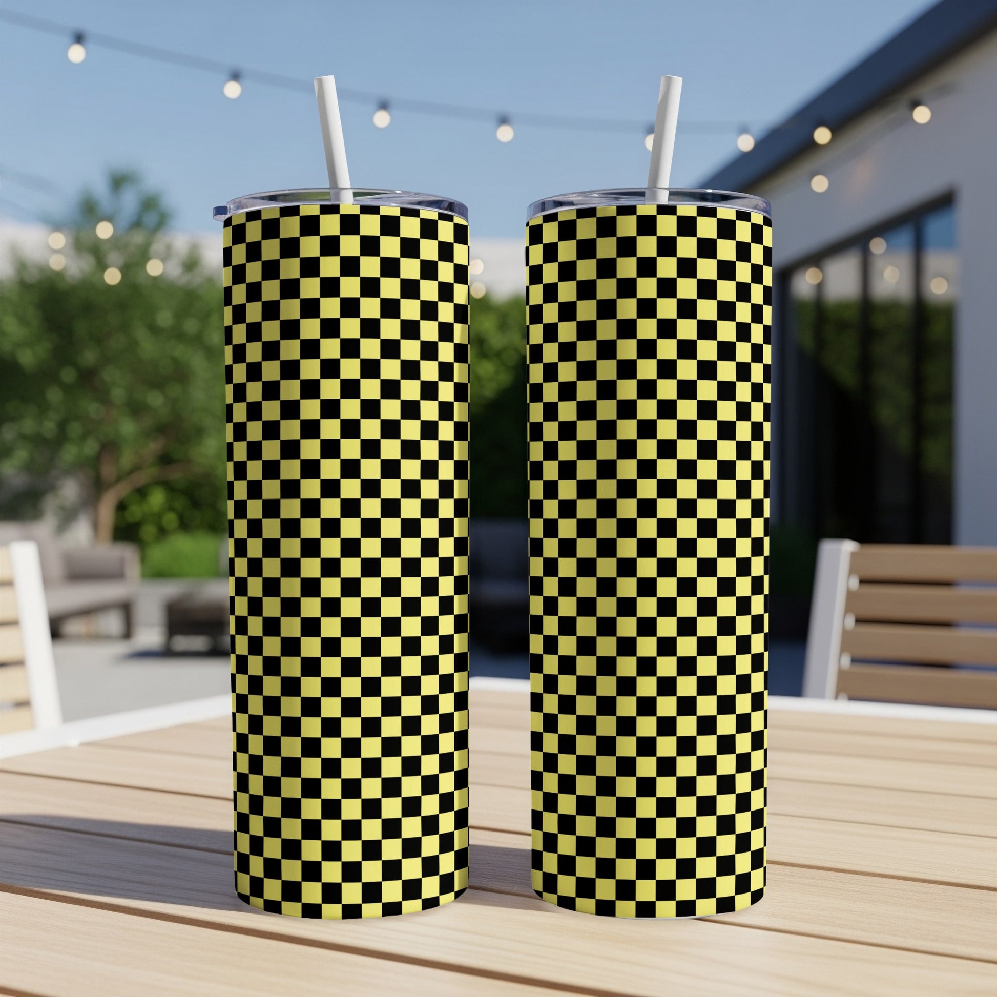 Two tall, skinny tumblers with a black and yellow checkerboard pattern.