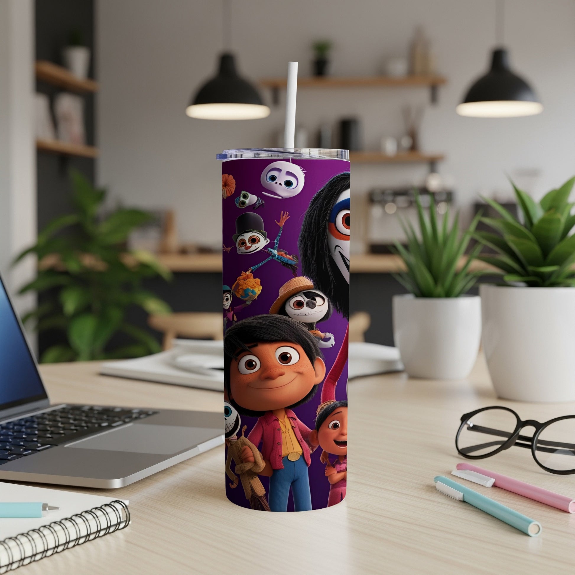 Cartoon characters on a white tumbler with a straw in a home office setting.