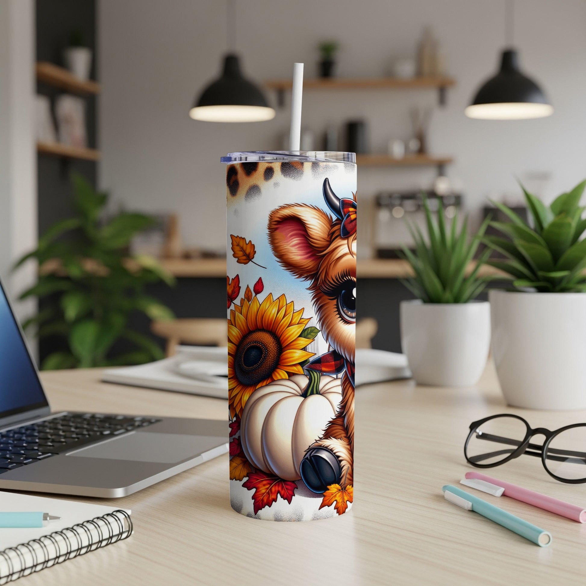 Cow and pumpkin illustration on a tumbler with sunflowers and autumn leaves.