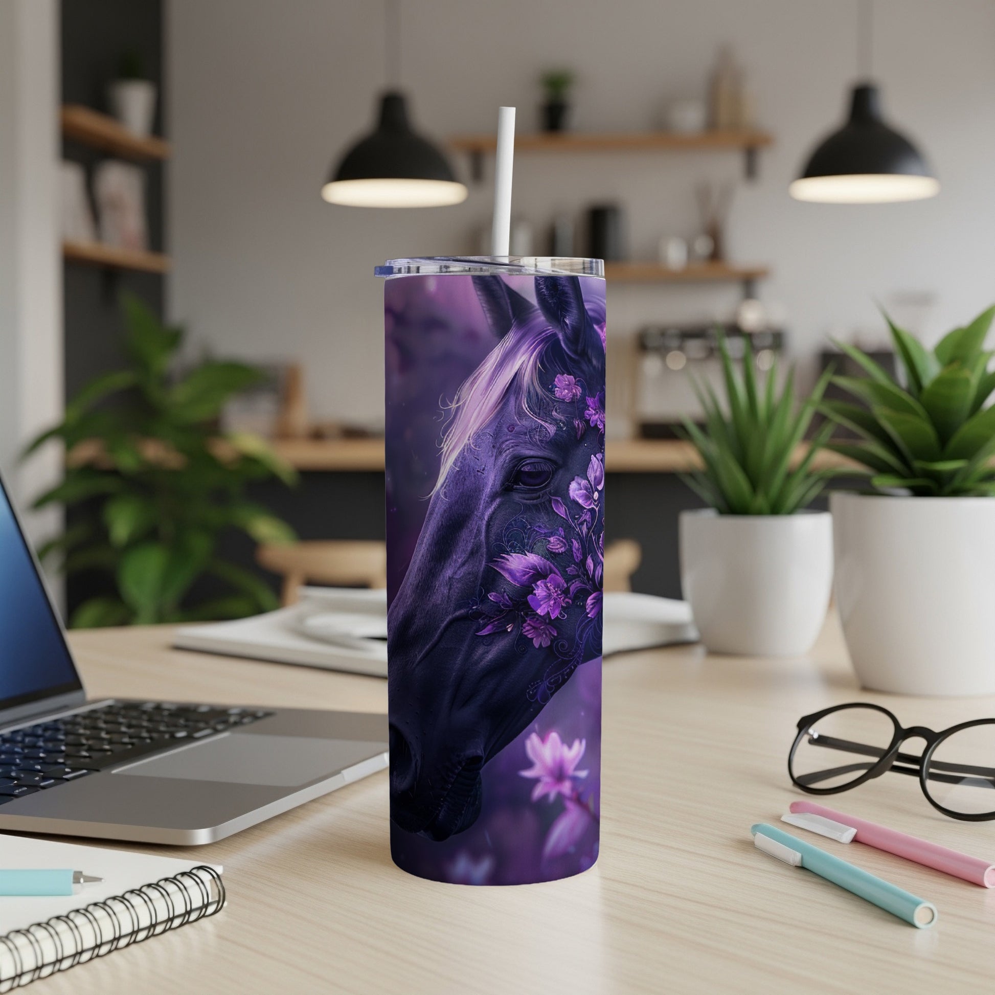 Dark horse head with floral accents on a purple tumbler, on a desk.