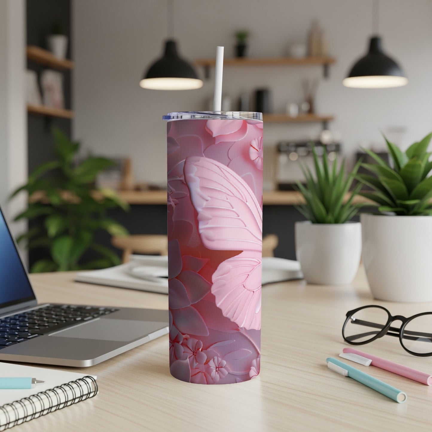 Pink butterfly wing pattern on a tumbler with a straw.