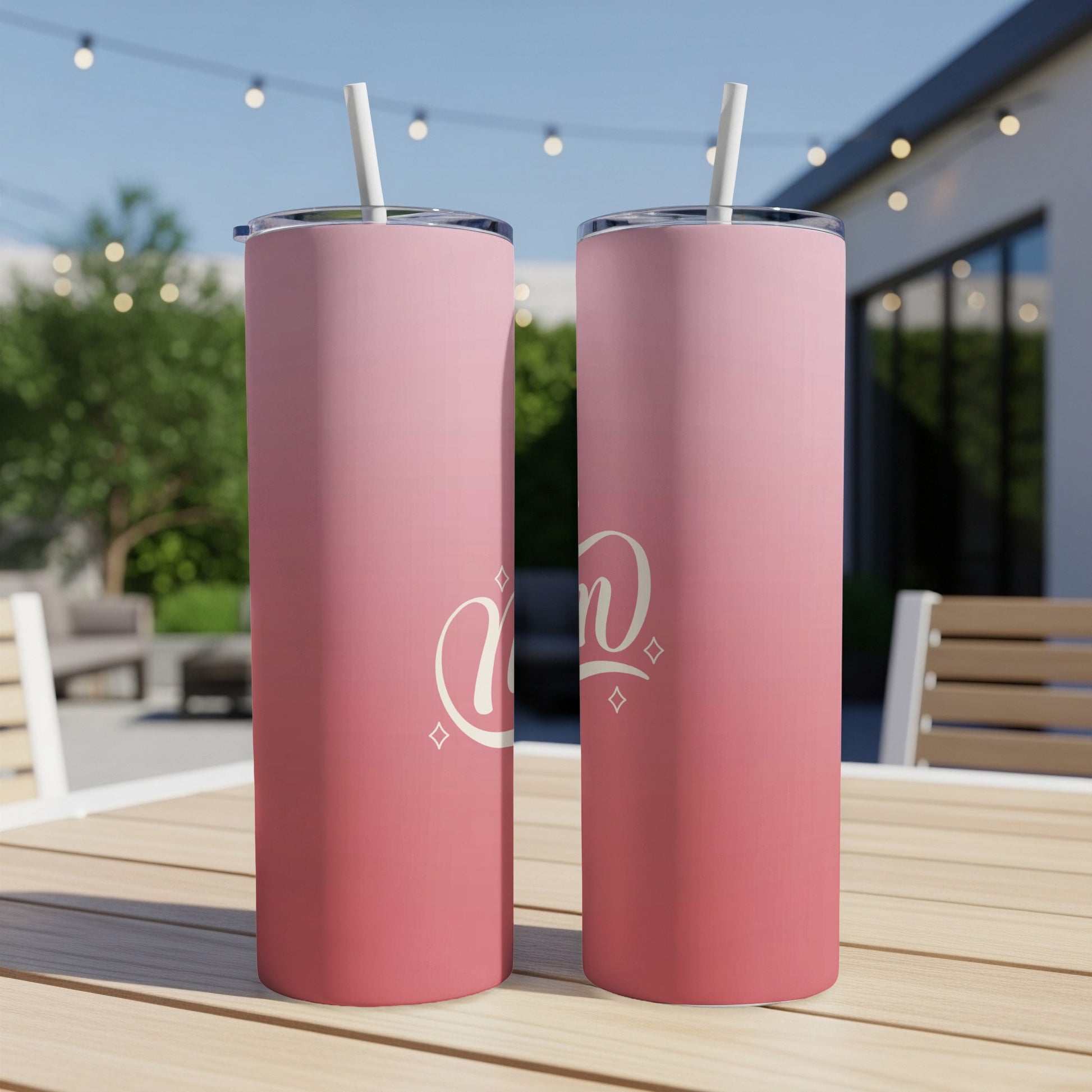Two pink gradient tumblers with "Mom" text on a table.
