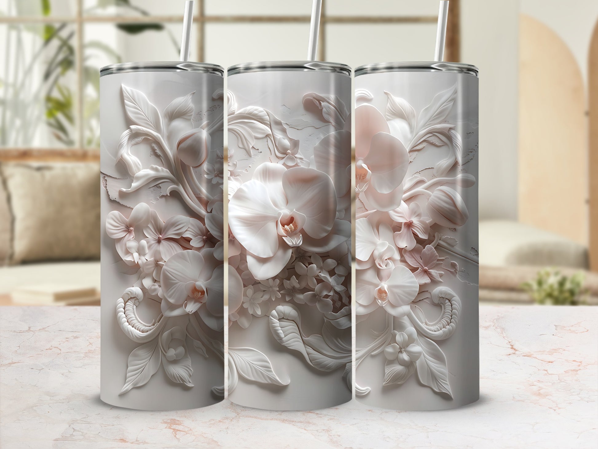 Three white tumblers with embossed floral orchid designs sit side-by-side.
