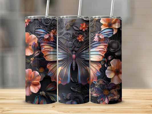 Three tumblers with colorful butterfly and floral designs on a wooden surface.