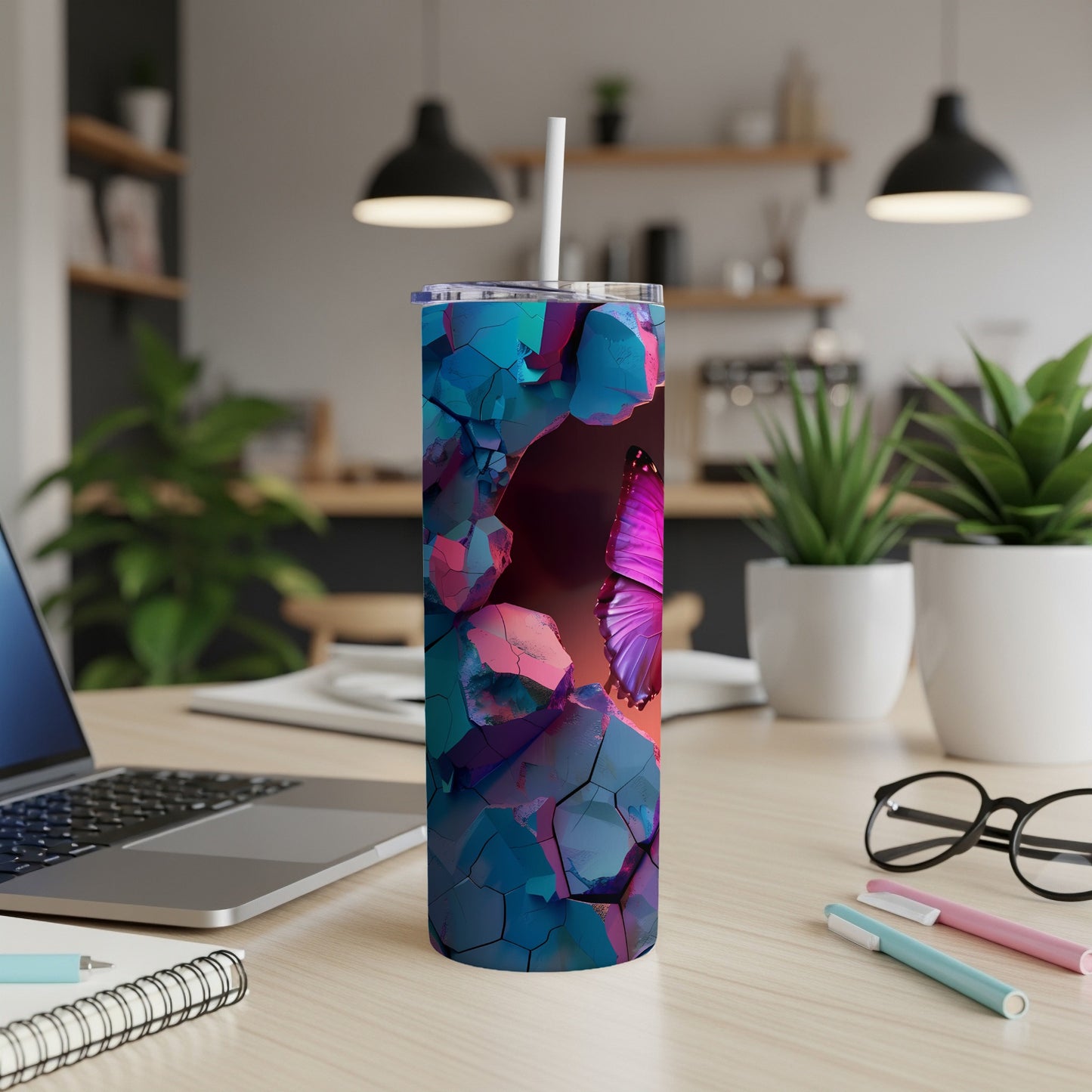 Butterfly and abstract geometric design on a blue and pink tumbler.