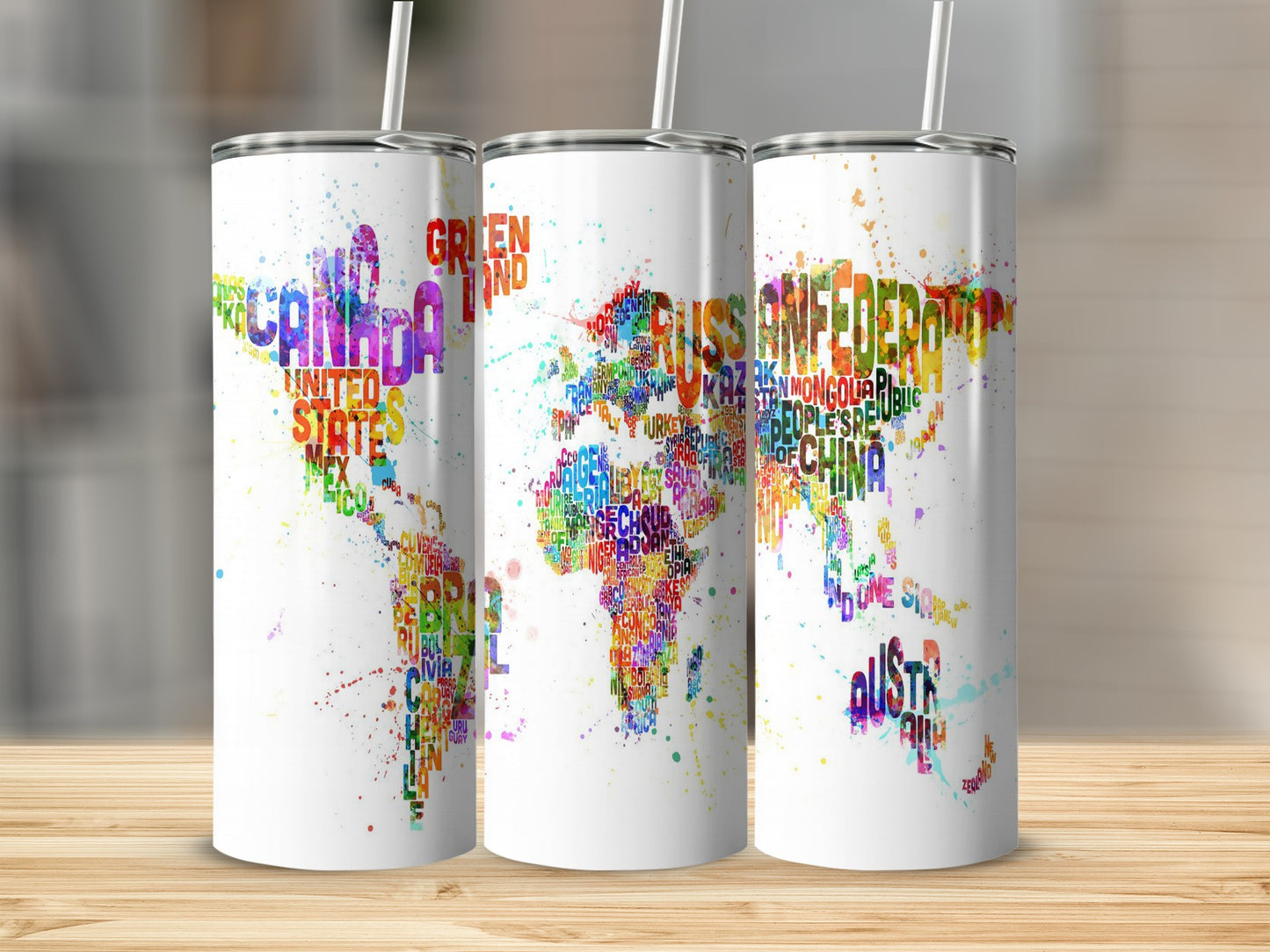 Three white tumblers with colorful world map design made of country names.