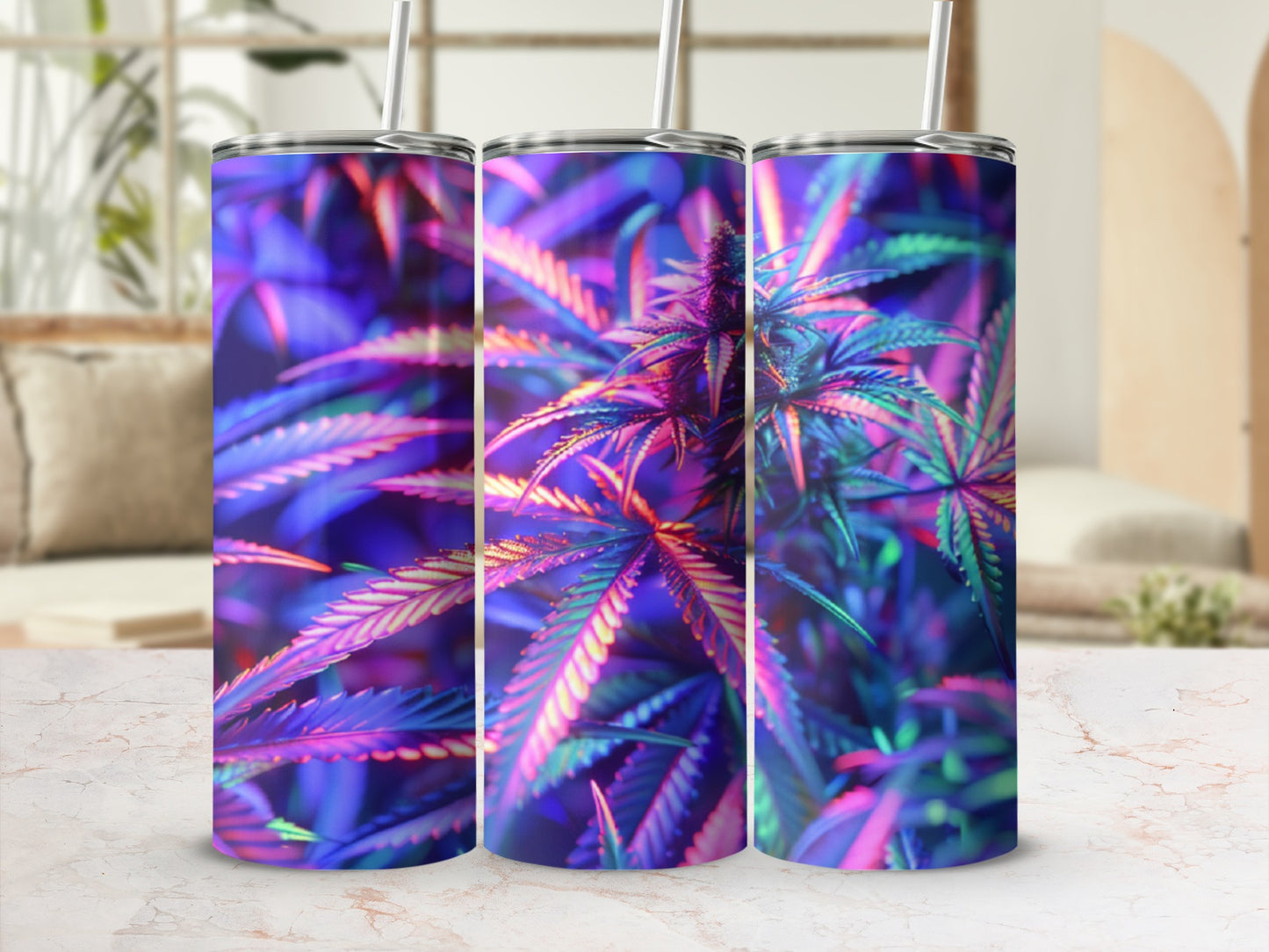 Three tumblers with colorful cannabis leaf design on marble surface.