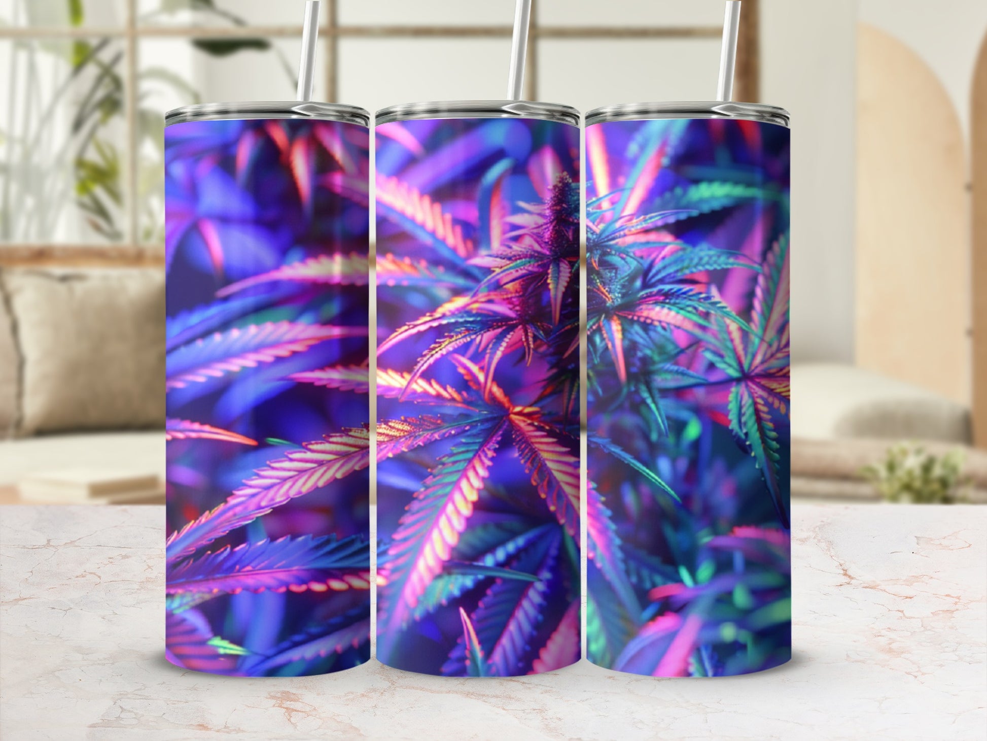 Three tumblers with colorful cannabis leaf design on marble surface.