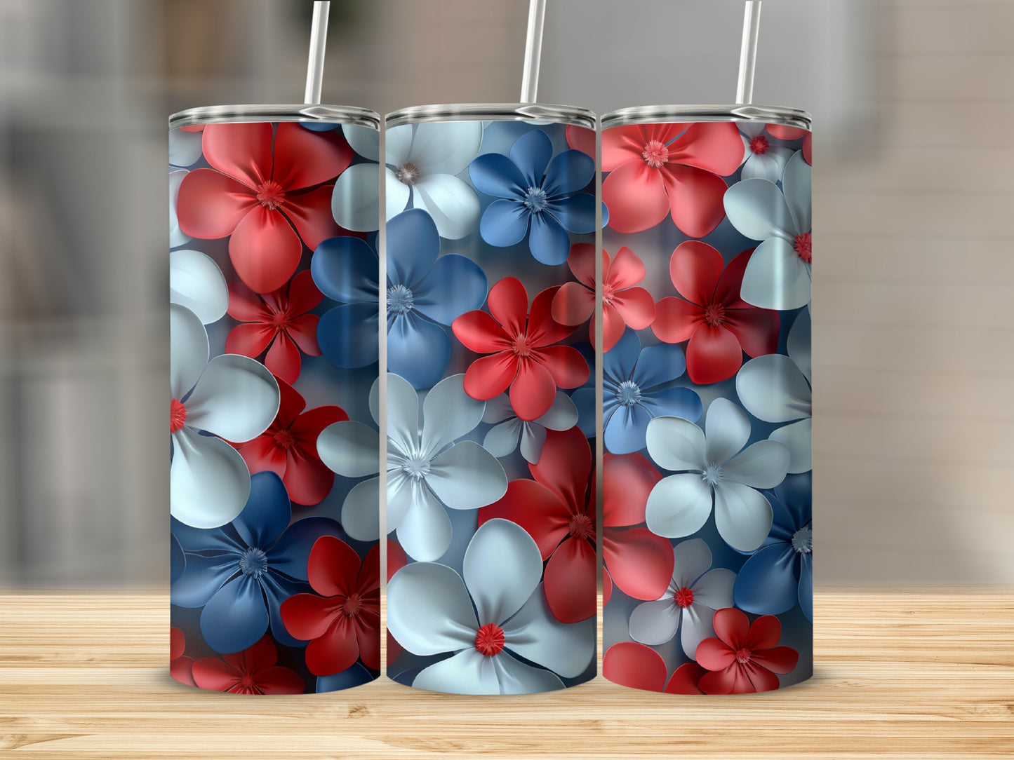 Three tumblers with red, white, and blue floral patterns on a wooden surface.