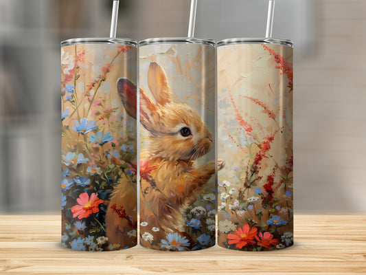 Triptych of tumblers featuring a painted rabbit among wildflowers.