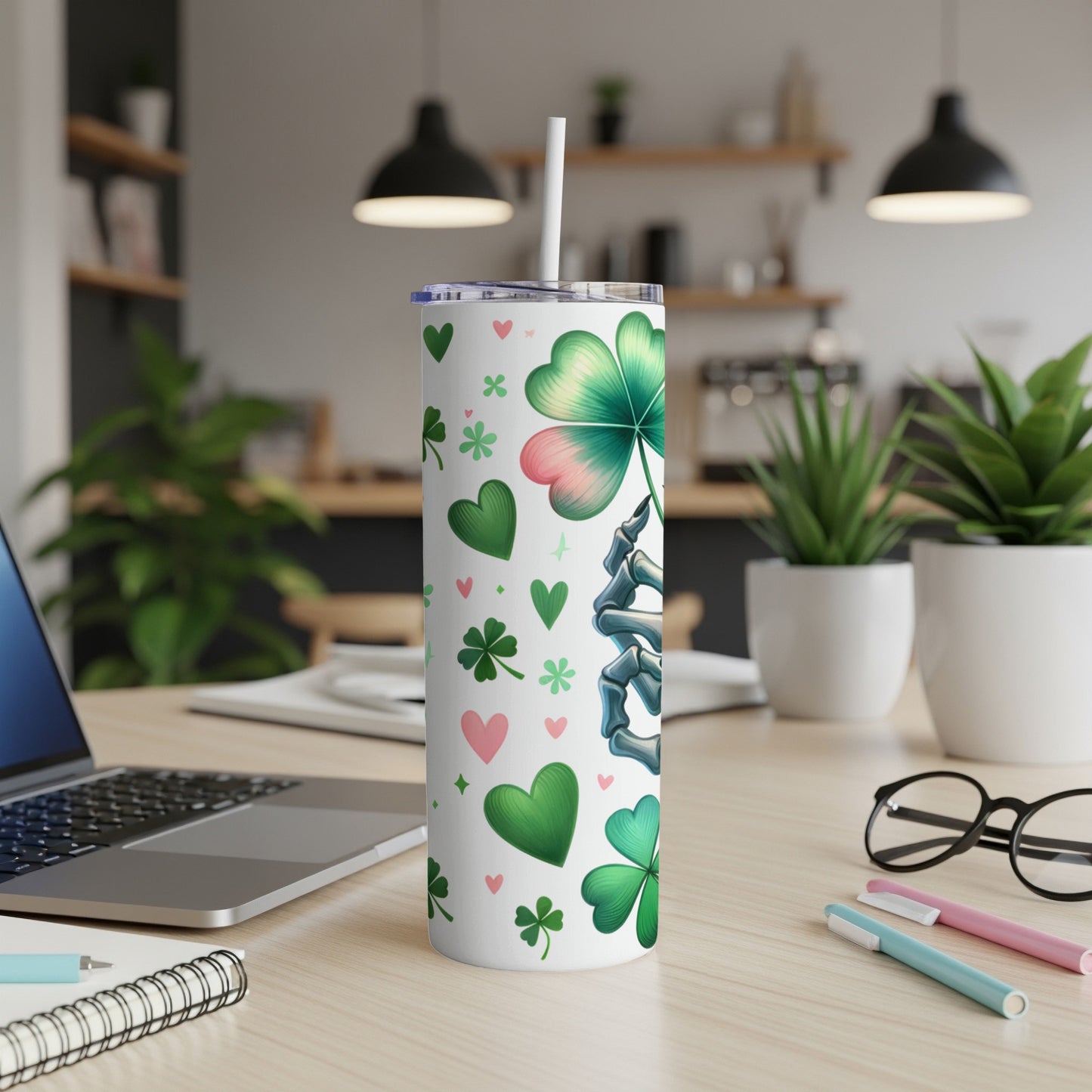 White tumbler with shamrocks, hearts, and a skeleton hand holding a shamrock.