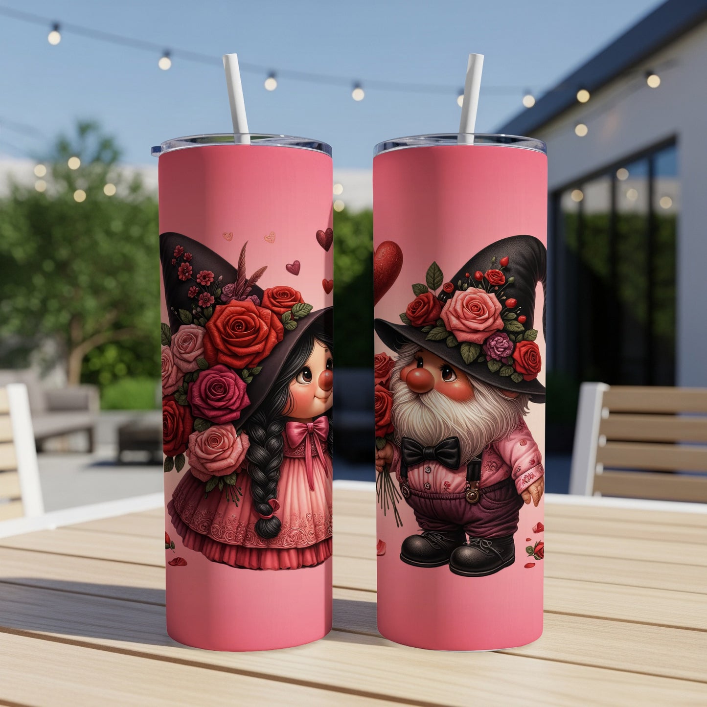 Two pink tumblers with gnome couple wearing hats adorned with roses.