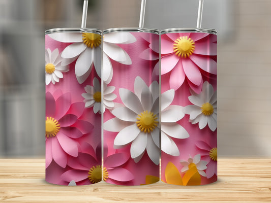 Three pink and white floral tumblers with straws on a wooden surface.