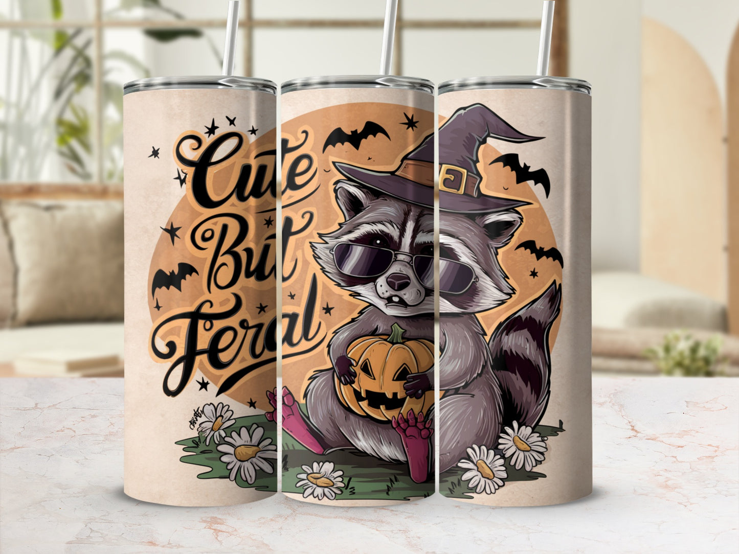 Tumblers featuring a raccoon in a witch hat holding a pumpkin with text "Cute But Feral".