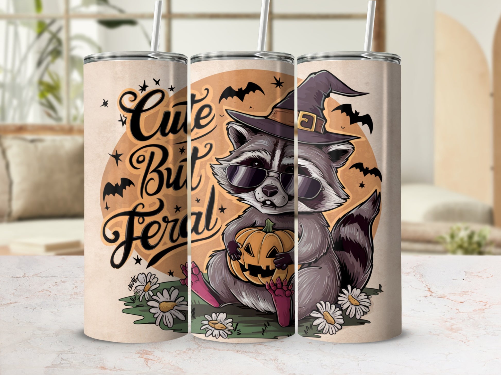 Tumblers featuring a raccoon in a witch hat holding a pumpkin with text "Cute But Feral".