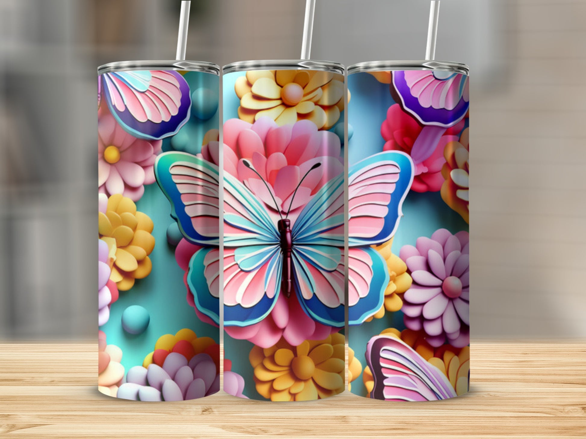Three tumblers featuring a blue butterfly and colorful flowers.