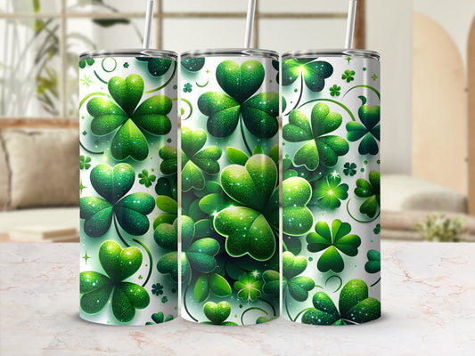 Three green shamrock patterned tumblers with straws.