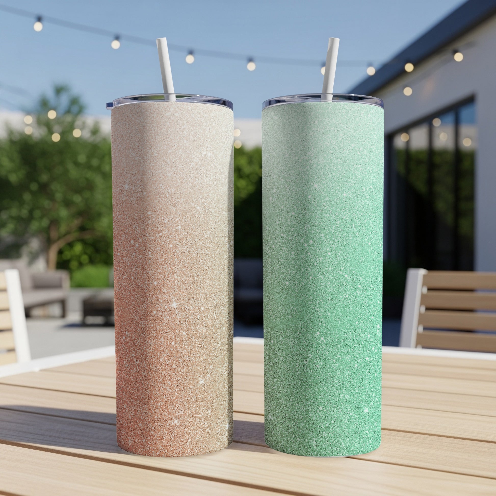 Two glitter tumblers, one rose gold and one mint green, on a table.