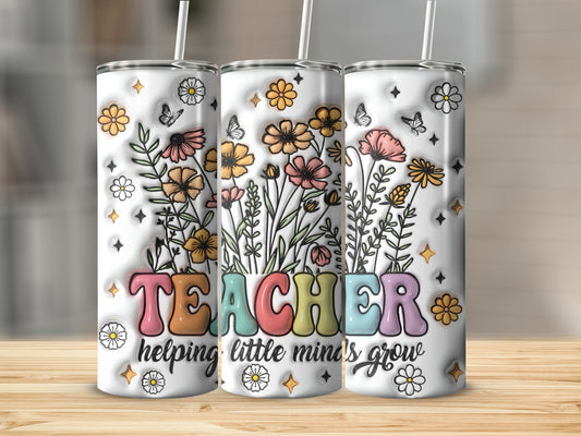 White tumbler with "TEACHER" in colorful letters and floral illustrations.