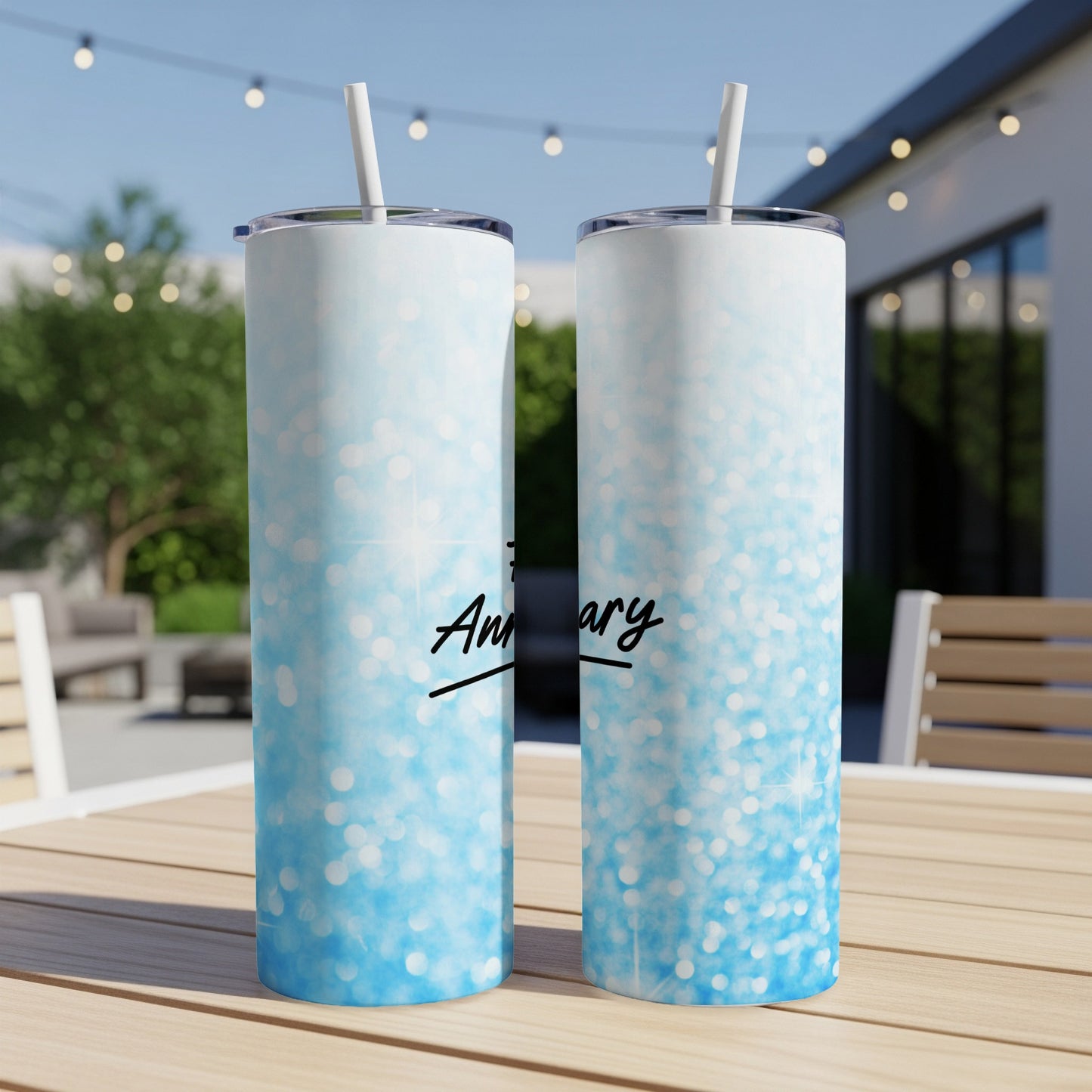 Two blue glitter tumblers with straws and "Anniversary" text.