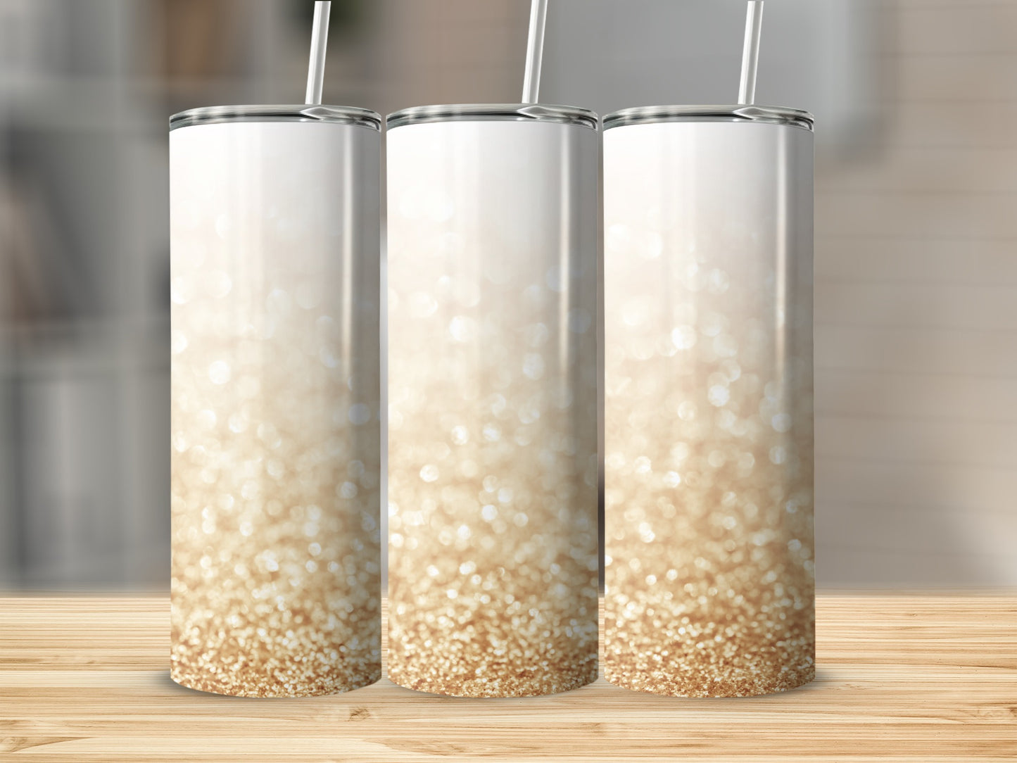 Three tall tumblers with a gold glitter ombre design.