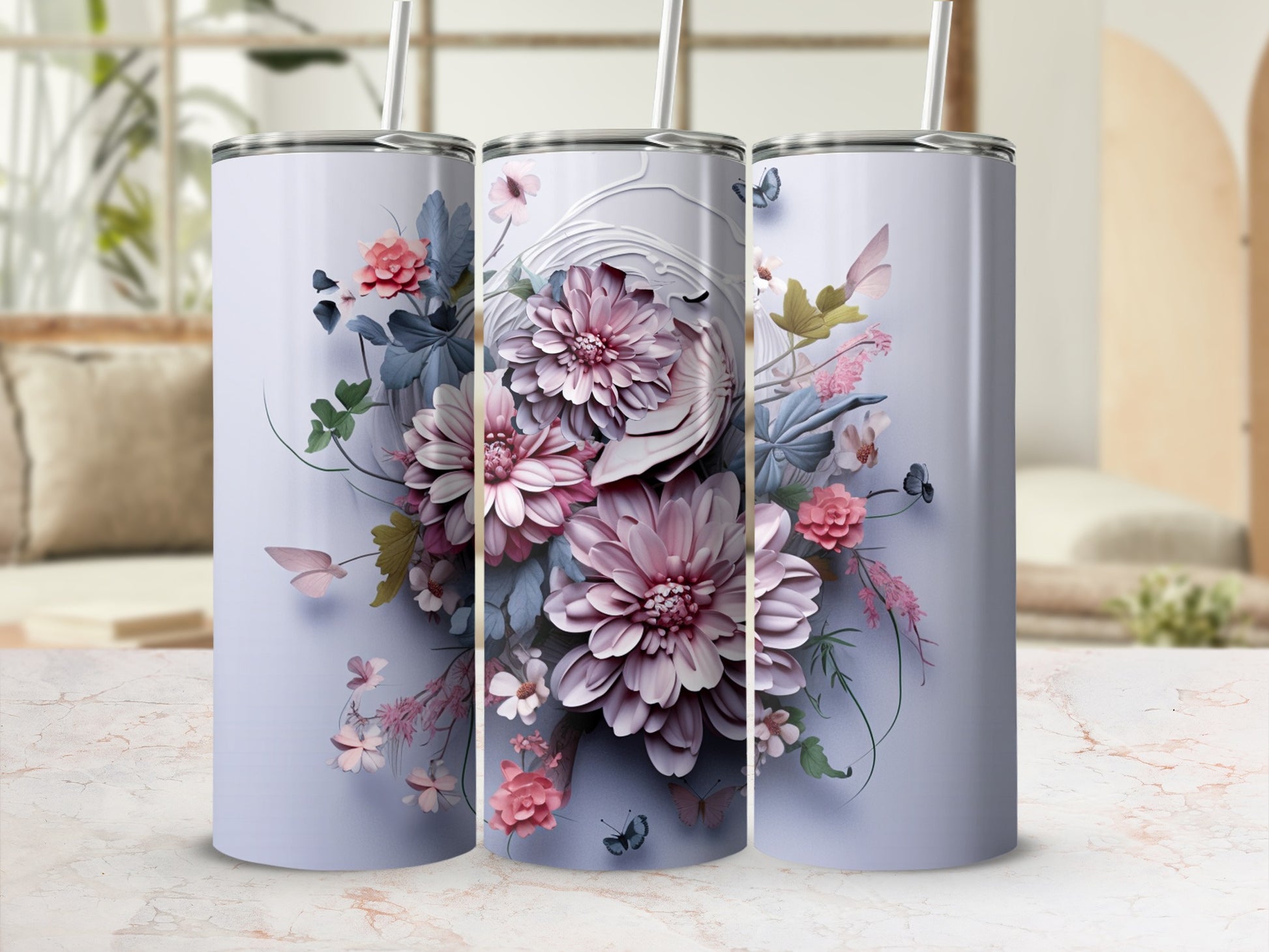 Three tumblers with pink and blue floral designs and butterflies.