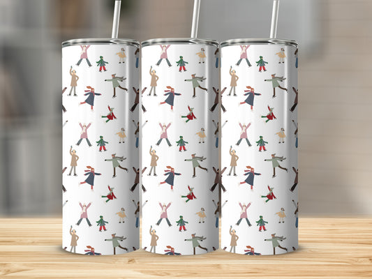 Three tumblers with a pattern of ice skaters on a wooden surface.