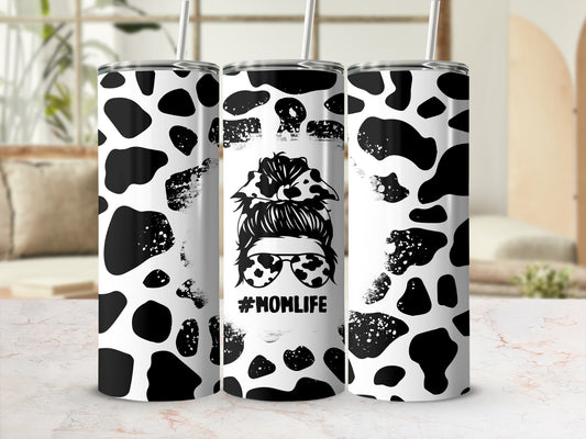 Black and white cow print tumbler with #MOMLIFE design.
