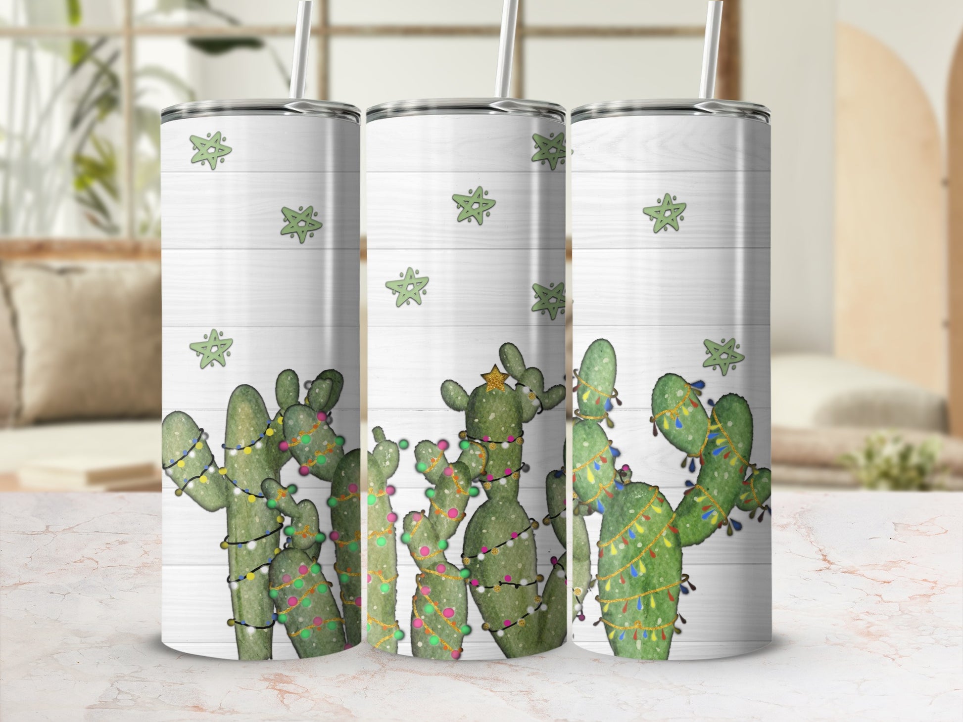 Three tumblers with a Christmas cactus design on a wooden background.