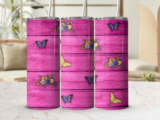 Three pink wooden tumblers with floral and butterfly designs.