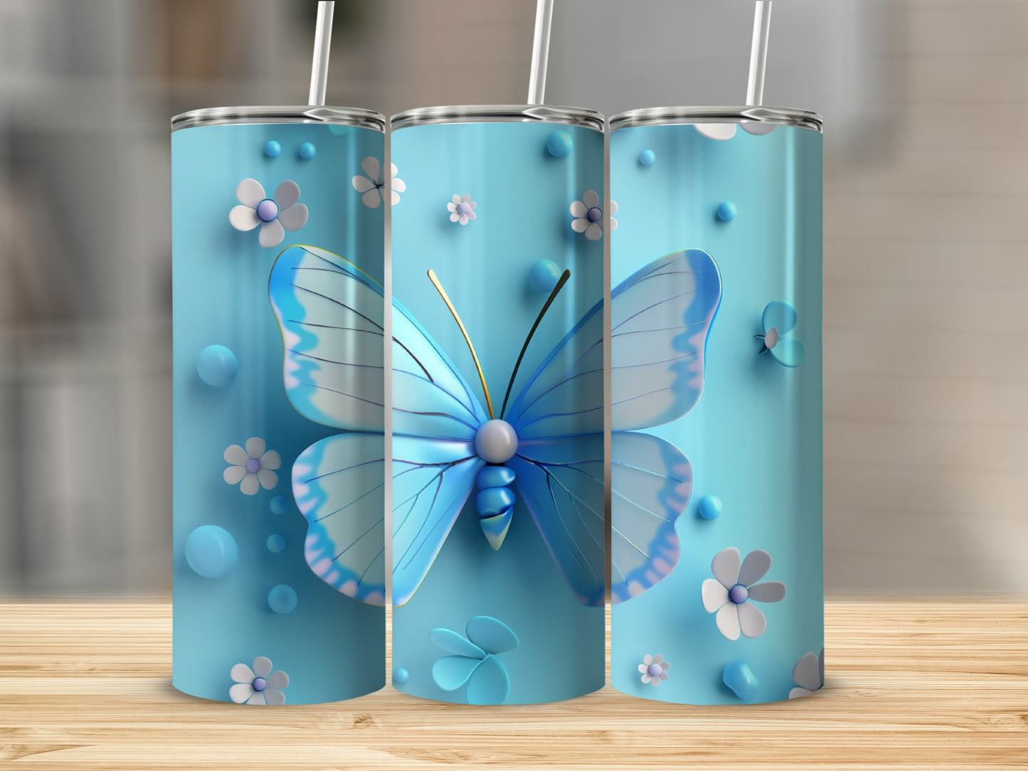 Three blue tumblers with butterflies and flowers.