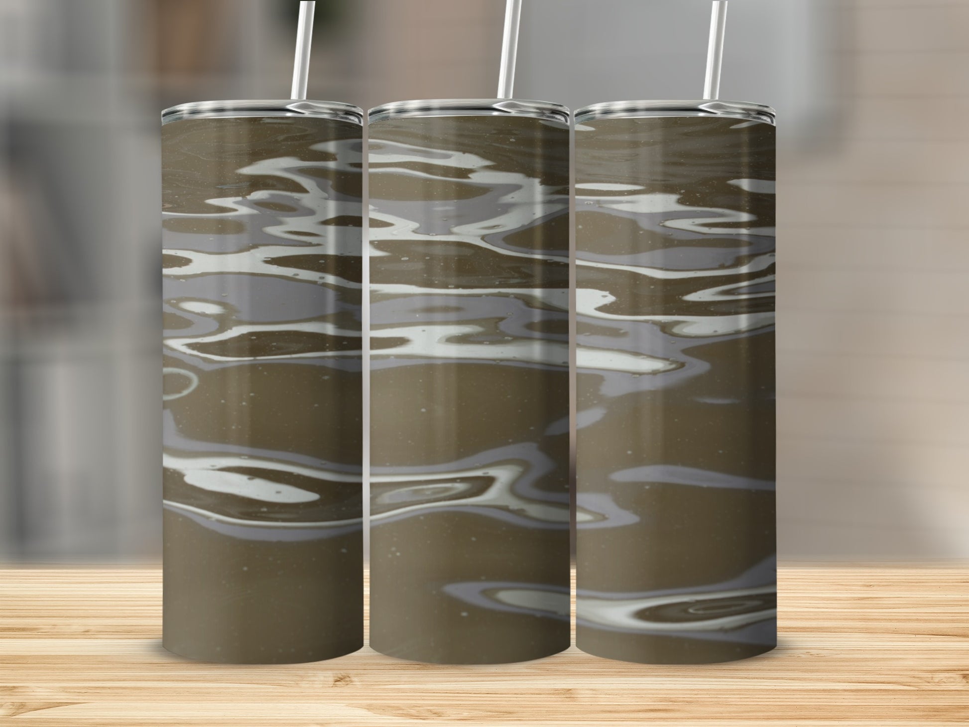 Three stainless steel tumblers with a swirling brown and gray abstract pattern.
