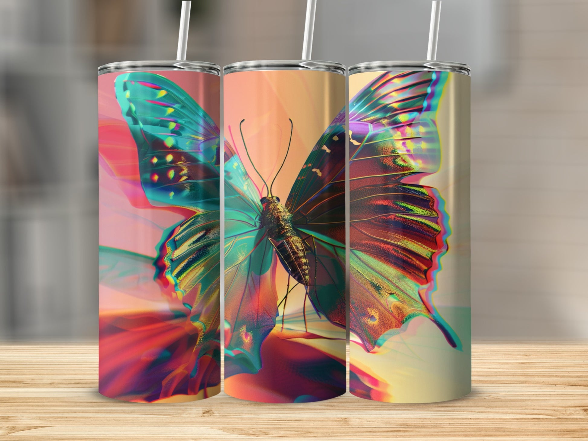 Three abstract butterfly tumblers with straw stands on a wooden surface.