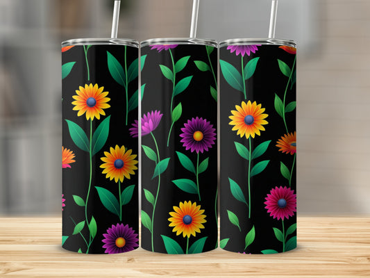 Three black tumblers with colorful floral patterns on a wooden surface.